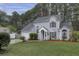 Charming two-story home with light siding, a well-manicured lawn, and mature trees providing a serene backdrop at 110 Mapperton Ct, Summerville, SC 29485