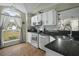 Bright kitchen featuring white cabinets, granite counters, and modern stainless steel appliances at 110 Mapperton Ct, Summerville, SC 29485