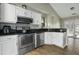 A well-equipped kitchen featuring stainless steel appliances, white cabinets, and a modern backsplash at 110 Mapperton Ct, Summerville, SC 29485