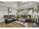 Cozy living room featuring hardwood floors, neutral colors, a fireplace, and large windows providing lots of natural light at 110 Mapperton Ct, Summerville, SC 29485