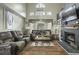 Comfortable living room featuring hardwood floors, a fireplace, and large windows providing lots of natural light at 110 Mapperton Ct, Summerville, SC 29485