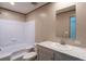 Clean bathroom with a bathtub, a white vanity with a marble top, and a framed mirror at 111 Sandy Oaks Ln, Cross, SC 29436