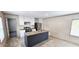 Spacious kitchen featuring gray and white cabinets, a stainless steel refrigerator, and a gray island at 111 Sandy Oaks Ln, Cross, SC 29436