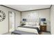 Cozy main bedroom with a tufted headboard bed, stylish decor, and a sliding door closet at 111 Sandy Oaks Ln, Cross, SC 29436