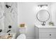 Beautiful white bathroom with updated vanity, tub with marble tile, and modern fixtures at 1114 Margaret Dr, Ladson, SC 29456