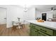 A bright kitchen with an island, eating nook and view into the living room creates a comfortable living space at 1114 Margaret Dr, Ladson, SC 29456