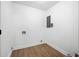 Empty laundry room with wood-look floors, white walls, and hookups ready for washer and dryer installation at 1114 Margaret Dr, Ladson, SC 29456