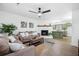 Inviting living room with brick fireplace, ceiling fan, and an open layout to the kitchen at 1114 Margaret Dr, Ladson, SC 29456