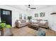 Bright living room featuring stylish decor, modern ceiling fan, and view of front door and windows at 1114 Margaret Dr, Ladson, SC 29456