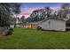 Large backyard features screened-in porch, green grass, and a white brick house at 123 Sharon Dr, Walterboro, SC 29488