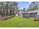 Great backyard view, featuring green grass and screened in porch at 123 Sharon Dr, Walterboro, SC 29488