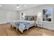 Calm bedroom with wood-look floors, light walls, a ceiling fan, and natural light through windows at 123 Sharon Dr, Walterboro, SC 29488