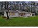 Charming single-story home with a brick exterior, inviting entrance, and well-manicured lawn and mature trees in the background at 123 Sharon Dr, Walterboro, SC 29488