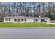 Charming single-story home with a brick exterior, inviting entrance and well-manicured lawn and trees in the background at 123 Sharon Dr, Walterboro, SC 29488