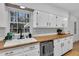 Bright kitchen featuring wood countertops, white cabinetry, modern hardware and a large window over the sink at 123 Sharon Dr, Walterboro, SC 29488