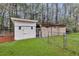 Backyard featuring two storage sheds with white and natural wood exteriors, fenced in for security and privacy at 123 Sharon Dr, Walterboro, SC 29488
