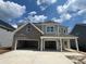 New construction home with a two-car garage, covered porch, and mixed brick and siding exterior at 136 Grange Cir, Summerville, SC 29486