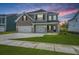 Beautiful two-story home with a well-manicured lawn and a gray exterior at 136 Grange Cir, Summerville, SC 29486