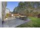 Spacious backyard patio with outdoor seating, grill, and a fire pit perfect for entertaining at 1376 Wild Goose Trl, Summerville, SC 29483