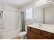 Bright bathroom with a tub and shower, framed mirror, and dark wood vanity at 1376 Wild Goose Trl, Summerville, SC 29483