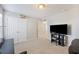 Comfortable bedroom with neutral walls, carpet, and a modern entertainment center setup at 1376 Wild Goose Trl, Summerville, SC 29483