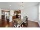 Inviting dining area featuring hardwood floors, modern chandelier, and seamless transition to the kitchen at 1376 Wild Goose Trl, Summerville, SC 29483