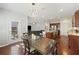 Open-concept dining area with a stylish chandelier, a wood table, and easy access to the kitchen at 1376 Wild Goose Trl, Summerville, SC 29483