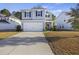 Traditional two-story home with a two-car garage, neutral siding, and well-manicured landscaping at 1376 Wild Goose Trl, Summerville, SC 29483