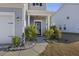 Charming home exterior featuring a welcoming front entrance, with decorative bushes and a lantern at 1376 Wild Goose Trl, Summerville, SC 29483
