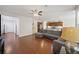 Open-concept living room with wood floors, a gray sectional, and seamless flow into the kitchen and dining area at 1376 Wild Goose Trl, Summerville, SC 29483