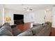 Cozy living room featuring dark wood floors, a comfortable sectional, and a modern entertainment center at 1376 Wild Goose Trl, Summerville, SC 29483