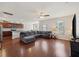 Spacious living room with dark wood floors, a comfortable gray sectional, and an open layout to the kitchen at 1376 Wild Goose Trl, Summerville, SC 29483