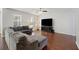 Bright living room with dark wood floors, a gray sectional, a ceiling fan and natural light at 1376 Wild Goose Trl, Summerville, SC 29483