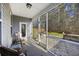 Cozy screened-in porch with a rocking chair and view of the backyard at 1376 Wild Goose Trl, Summerville, SC 29483