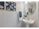 Stylish powder room with shell art, vessel sink, round mirror, and a white towel at 138 Taylor Cir, Goose Creek, SC 29445