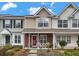 Charming townhomes featuring landscaped front yards and covered front porches with seating areas at 138 Taylor Cir, Goose Creek, SC 29445