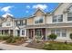 Charming townhomes featuring landscaped front yards and covered front porches with seating areas at 138 Taylor Cir, Goose Creek, SC 29445