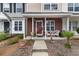 Charming townhome featuring a brick facade, covered front porch, and a cozy seating area at 138 Taylor Cir, Goose Creek, SC 29445