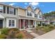 Charming townhomes featuring landscaped front yards and covered front porches with seating areas at 138 Taylor Cir, Goose Creek, SC 29445