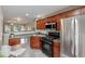 Modern kitchen featuring stainless steel appliances, dark wood cabinets, and open layout to living area at 138 Taylor Cir, Goose Creek, SC 29445