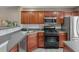 Modern kitchen featuring stainless steel appliances, dark wood cabinets, and open layout to living area at 138 Taylor Cir, Goose Creek, SC 29445