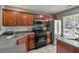 Modern kitchen featuring stainless steel appliances, dark wood cabinets, and open layout to living area at 138 Taylor Cir, Goose Creek, SC 29445