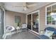 Cozy screened-in porch with comfortable seating, ceiling fan, and natural light at 138 Taylor Cir, Goose Creek, SC 29445