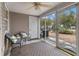 Cozy sunroom with neutral decor and sliding glass doors leading to the backyard at 138 Taylor Cir, Goose Creek, SC 29445