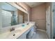 Bathroom featuring a double vanity, ample lighting, and a tiled shower at 1529 Wellesley Cir, Mount Pleasant, SC 29466