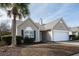 Charming single-story home featuring a well-manicured lawn, palm tree, and an attached two-car garage at 1529 Wellesley Cir, Mount Pleasant, SC 29466