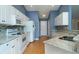 Bright kitchen featuring white cabinets, tile backsplash, light countertops and wood flooring at 1529 Wellesley Cir, Mount Pleasant, SC 29466