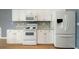 Bright kitchen featuring white cabinetry, modern appliances, granite countertops, and stylish backsplash at 1529 Wellesley Cir, Mount Pleasant, SC 29466