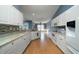 Updated kitchen featuring white cabinets, modern appliances, light countertops and wood flooring at 1529 Wellesley Cir, Mount Pleasant, SC 29466