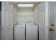 Convenient laundry closet with a washer, dryer, and shelving for organized storage at 1529 Wellesley Cir, Mount Pleasant, SC 29466